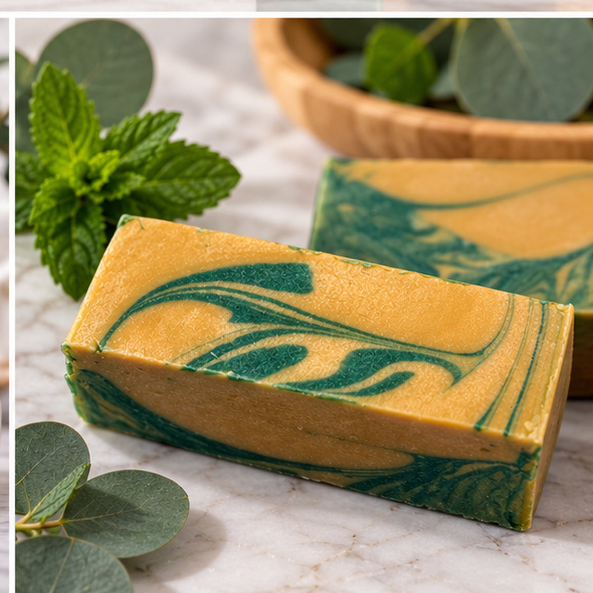Eucalyptus Mint Soap bar on marble soap dish showing vibrant gold and green swirl with mint leaves
